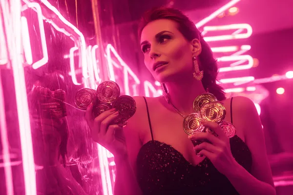 A glamorous woman holding casino chips in a neon-lit environment, representing the premium online casino atmosphere of WAGIPLUS.
