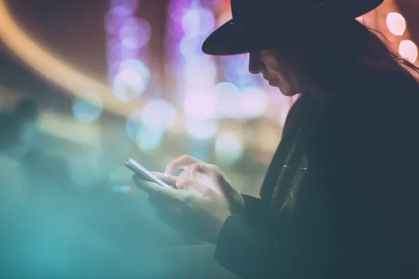 A confident dealer surrounded by casino chips inviting players to access their WAGIPLUS account, reflecting quick and easy login options.